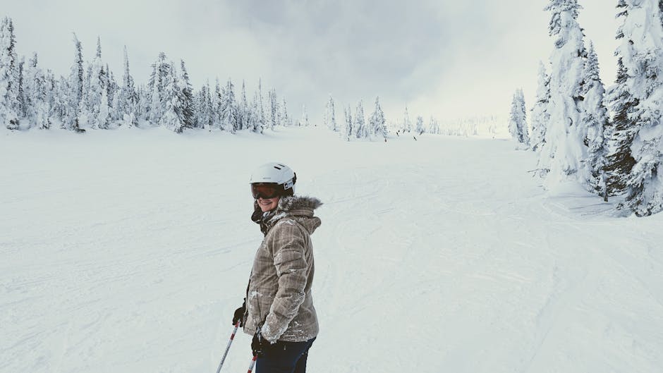 Explore the thrilling ski slopes of Kelowna, BC, amid stunning snowy landscapes and frosty pine trees.