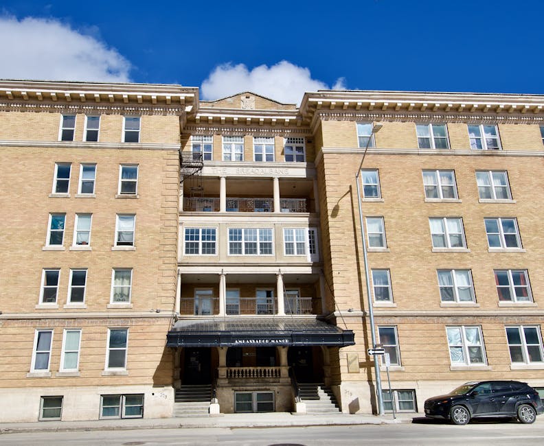 Facade of a historic apartment building in Winnipeg, Manitoba, captured on a sunny day.