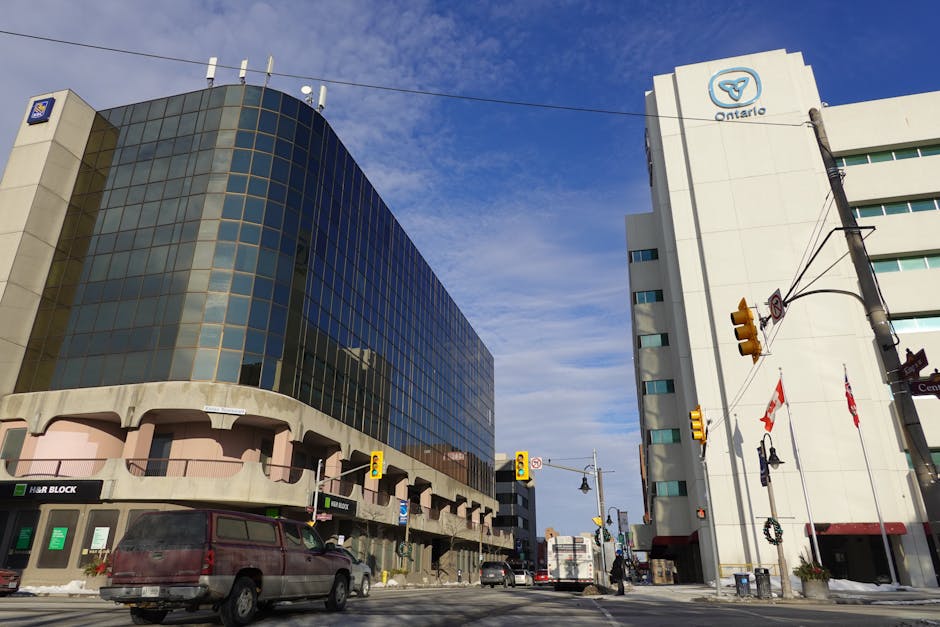 Low angle view of modern office buildings and traffic in downtown Oshawa, Ontario, Canada.