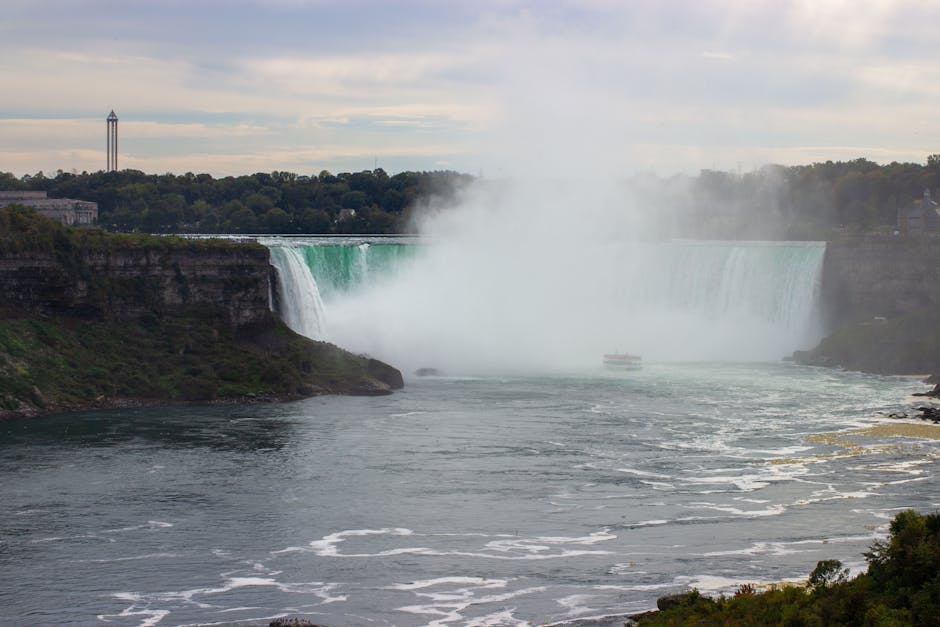 Experience the power and beauty of Niagara Falls in this misty landscape view.
