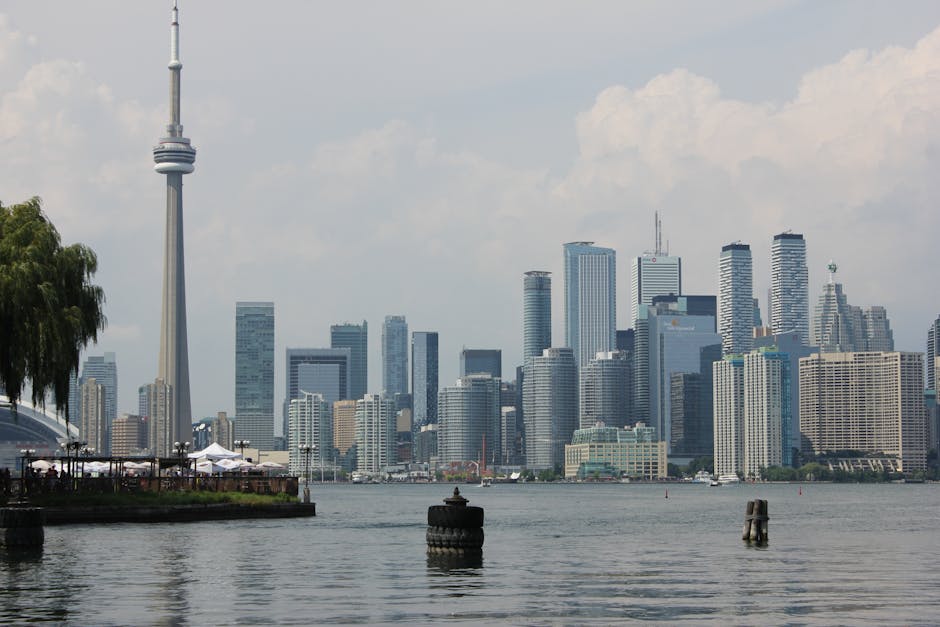 Stunning view of Toronto skyline featuring the iconic CN Tower and Lake Ontario.