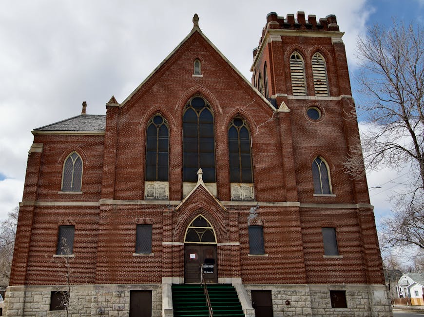 Front view of a historic brick church with gothic elements in Winnipeg.