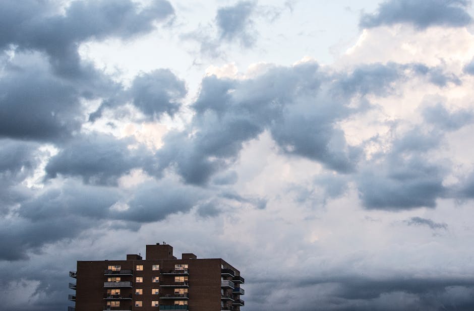 Dramatic clouds over an apartment building in Winnipeg, Canada, creating a moody urban landscape.